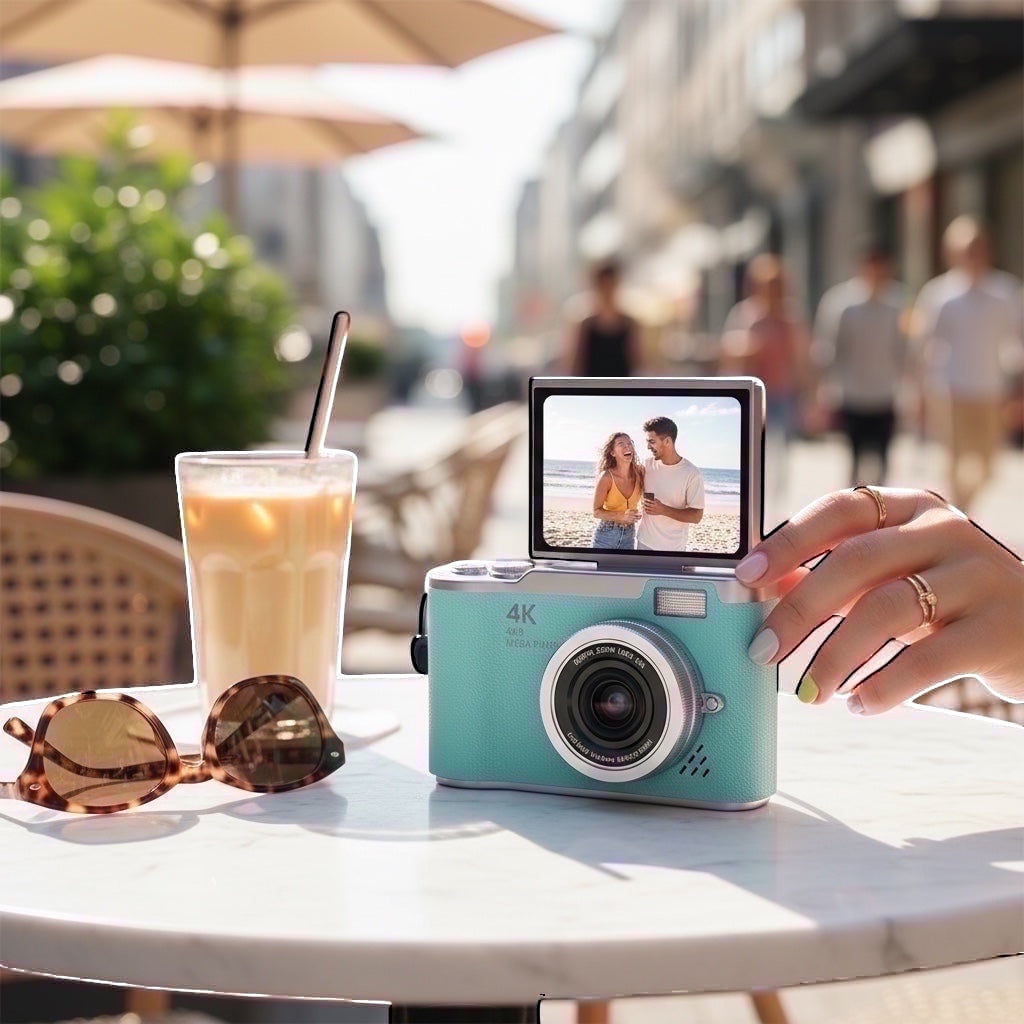 Pixie 4K digital camera in teal with a flip screen showing a woman, 48MP, 18x zoom lens.